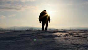 Silhouette walking in deep snow