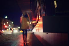 Silhouette of woman in city night lights