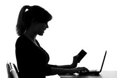 Silhouette of a woman makes online purchase at home Royalty Free Stock Images Silhouette of a woman makes online purchase at home Royalty Free Stock Images