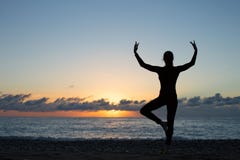 Silhouette of woman doing yoga on the beach at sunset royalty free stock photography Silhouette of woman doing yoga on the beach at sunset royalty free stock photography