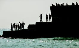 Silhouetted People On Brighton Coast Stock Images