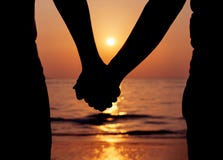 Silhouettes couples holding hands