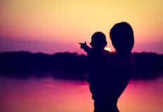 Silhouettes of Father and Baby Watching Sunset stock photography Silhouettes of Father and Baby Watching Sunset stock photography