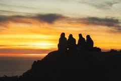 Silhouettes Of Friends Travelers On Top Of A Hill Watching A Beautiful Sunset And Talking, California Stock Photos