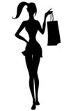 Silhueta da menina bonita com sacos de compras à disposição Fotos de Stock Silhueta da menina bonita com sacos de compras à disposição Fotos de Stock