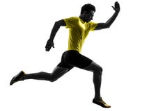 Silhueta running do corredor do velocista do homem novo imagens de stock Silhueta running do corredor do velocista do homem novo imagens de stock