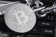 Silver bitcoin close-up. Electronic payments, blockchain technology. keyboard. stacking stock image Silver bitcoin close-up. Electronic payments, blockchain technology. keyboard. stacking stock image