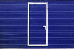 Simple Door In Blue Wall Stock Image