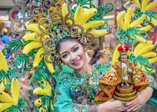 Sinulog dancer proudly holding the Santo Niño statue