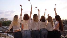 Six seductive young women are standing on a terrace in a row from their back. Wearing casual clothes, white shirts and stock video footage Six seductive young women are standing on a terrace in a row from their back. Wearing casual clothes, white shirts and stock video footage