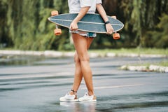 Skater Girl Standing Crossed Legs Holding Her Longboard Behind H Stock Photo Skater Girl Standing Crossed Legs Holding Her Longboard Behind H Stock Photo