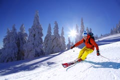 Skier Skiing Downhill In High Mountains Against Sunset Royalty Free Stock Images Skier Skiing Downhill In High Mountains Against Sunset Royalty Free Stock Images