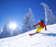 Skier Skiing Downhill In High Mountains Against Sunset Royalty Free Stock Images