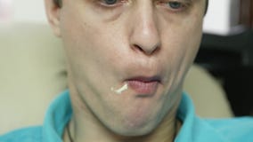 Skinny man eats fast food snack with great enjoyment. guy chewing junk food with big appetite. slow motion stock video Skinny man eats fast food snack with great enjoyment. guy chewing junk food with big appetite. slow motion stock video