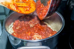 Skottet av att göra till kok hemmet gjorde läcker spagetti med tomatsås överst av en ugn arkivfoton Skottet av att göra till kok hemmet gjorde läcker spagetti med tomatsås överst av en ugn arkivfoton
