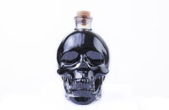 Skull Glass Bottle with black liquid stock image Skull Glass Bottle with black liquid stock image