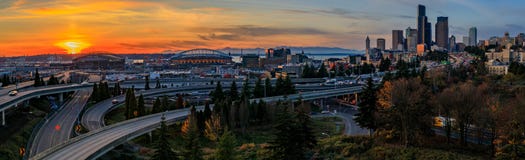 Skyline e arranha-céus do centro de Seattle além do intercâmbio da autoestrada de I-5 I-90 no por do sol na queda com folha amare imagens de stock Skyline e arranha-céus do centro de Seattle além do intercâmbio da autoestrada de I-5 I-90 no por do sol na queda com folha amare imagens de stock