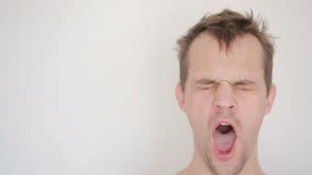 Slaperige slordige mens die de camera, geeuw onderzoeken stock videobeelden Slaperige slordige mens die de camera, geeuw onderzoeken stock videobeelden