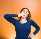 Sleep deprived young woman placing hand on mouth yawning royalty free stock photography Sleep deprived young woman placing hand on mouth yawning royalty free stock photography