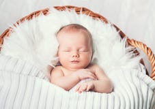 Sleeping newborn baby in a wrap on white blanket. Stock Photography Sleeping newborn baby in a wrap on white blanket. Stock Photography