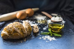 Sliced bread and bread ingredients on the black slates, close up royalty free stock photography Sliced bread and bread ingredients on the black slates, close up royalty free stock photography