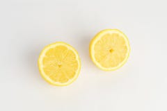 Sliced and cut tasty lemon fruit on white background. stock photos Sliced and cut tasty lemon fruit on white background. stock photos