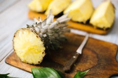 Sliced fresh pineapple on a wooden background in sunlight Stock Photography Sliced fresh pineapple on a wooden background in sunlight Stock Photography