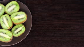 Sliced kiwi on a plate, on a dark background royalty free stock photography Sliced kiwi on a plate, on a dark background royalty free stock photography