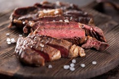Sliced medium rare grilled beef steak ribeye close-up