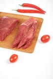 Sliced raw beef on cutting board and vegetables isolated on white background royalty free stock photo Sliced raw beef on cutting board and vegetables isolated on white background royalty free stock photo
