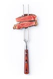 Slices of beef steak on meat fork