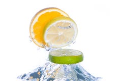 Slices of citrus fruit jumping out of the water stock photography Slices of citrus fruit jumping out of the water stock photography