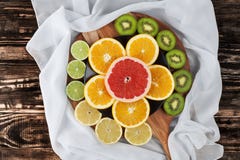 Slices Of Citrus Fruits On Chopping Board With Silk Royalty Free Stock Images Slices Of Citrus Fruits On Chopping Board With Silk Royalty Free Stock Images