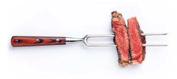 Slices of steak on meat fork