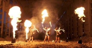 Slow motion: Fire show in the hangar show three female artist and a man with flamethrowers. stock video Slow motion: Fire show in the hangar show three female artist and a man with flamethrowers. stock video
