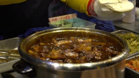 Slow Motion of vendor cooking stewed pork at roadside stands. Delicious meat stock footage Slow Motion of vendor cooking stewed pork at roadside stands. Delicious meat stock footage