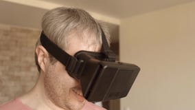 Sluit omhoog van de grijze haired mens die pret hebben thuis gebruikend zijn mobiele telefoonvr hoofdtelefoon Virtueel werkelijkh stock videobeelden Sluit omhoog van de grijze haired mens die pret hebben thuis gebruikend zijn mobiele telefoonvr hoofdtelefoon Virtueel werkelijkh stock videobeelden