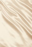 Slätt elegant guld- silke som bröllopbakgrund I tonad sepia arkivfoto Slätt elegant guld- silke som bröllopbakgrund I tonad sepia arkivfoto