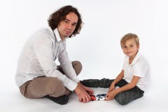 A child boy playing with toys with his dad stock photo A child boy playing with toys with his dad stock photo