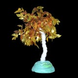 Small artificial tree with golden leaves. The object is isolated on a black background. royalty free stock images Small artificial tree with golden leaves. The object is isolated on a black background. royalty free stock images