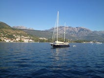 Small boat on calm Montenegro waters stock photo Small boat on calm Montenegro waters stock photo