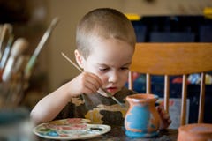 Small Boy Pains The Clay Jar Royalty Free Stock Photos