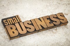 Small business in wood type. Small business text in vintage letterpress wood type on a ceramic tile background Small business in wood type. Small business text in vintage letterpress wood type on a ceramic tile background