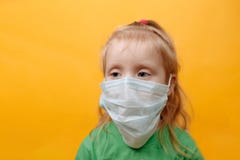 Download A Small Child In A Medical Mask On A Yellow Background Stock Photo Image Of Pandemic Mask 177923382 PSD Mockup Templates