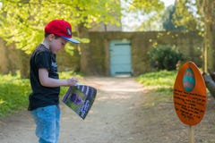 DERBYSHIRE, UK - 21ST APRIL 2019: A small child takes part in an Easter Egg hunt at Hardwick Hall stock image DERBYSHIRE, UK - 21ST APRIL 2019: A small child takes part in an Easter Egg hunt at Hardwick Hall stock image