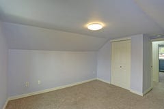 Small empty blue bedroom accented with vaulted ceiling stock photos Small empty blue bedroom accented with vaulted ceiling stock photos