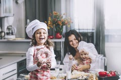 Small Girl Child Eats A Donut With My Mom And Sister Happy Cook Stock Photo Small Girl Child Eats A Donut With My Mom And Sister Happy Cook Stock Photo