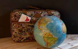 A small gobelin suitcase with a card in a pocket with a picture of hearts stock photography A small gobelin suitcase with a card in a pocket with a picture of hearts stock photography
