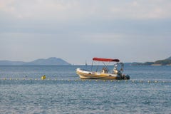 Small rubber motor boat, dinghy in morning light royalty free stock photo Small rubber motor boat, dinghy in morning light royalty free stock photo