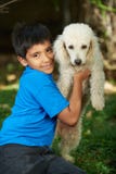 Small smiling boy with poodle dog Stock Images Small smiling boy with poodle dog Stock Images